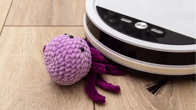 Picyure of DJI Romo Robot Vacuum vacuuming a toy