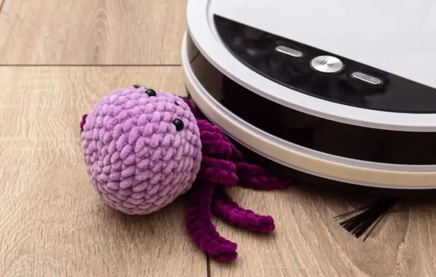 Picyure of DJI Romo Robot Vacuum vacuuming a toy